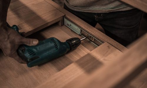 man-using-hand-drill-3637784-scaled.jpg handyman